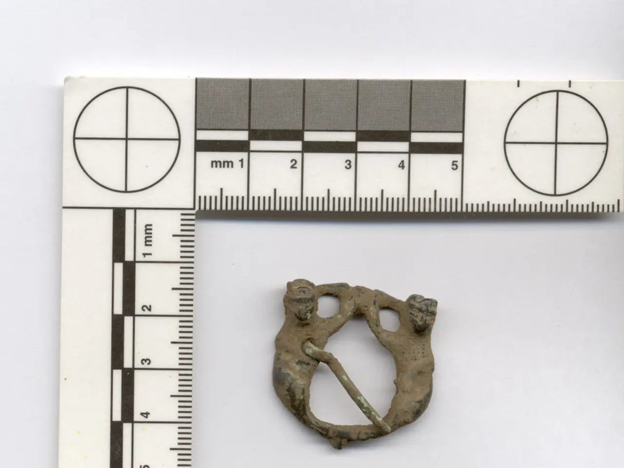 In this image I can see a marking tool with numbers. I can see an antique piece in the center of...