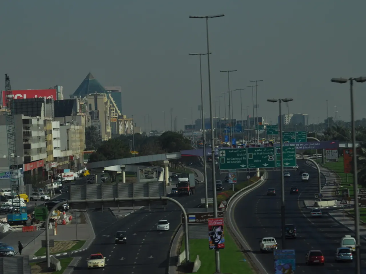 This is the aerial view of a city. in this we can see buildings, towers, motor vehicles,...