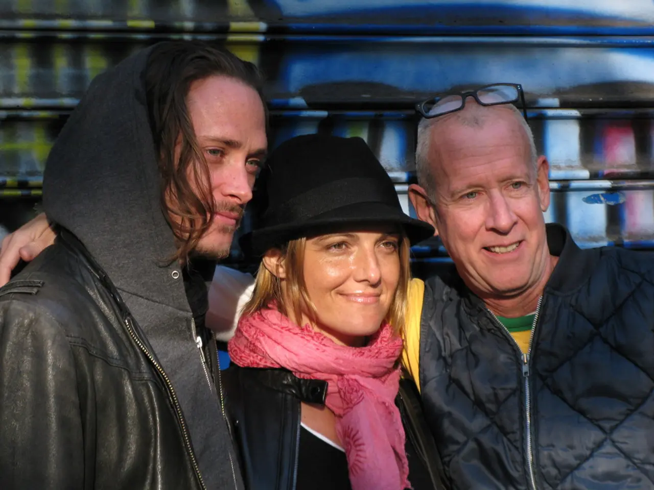 In the center of the image we can see three persons are standing and they are in different costumes...