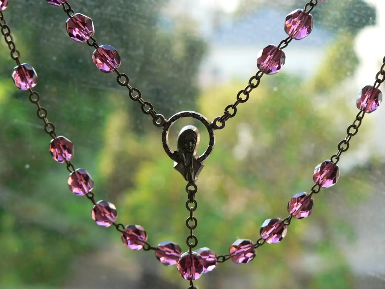 It looks like a chain. In the middle it is a locket of a human shaped.