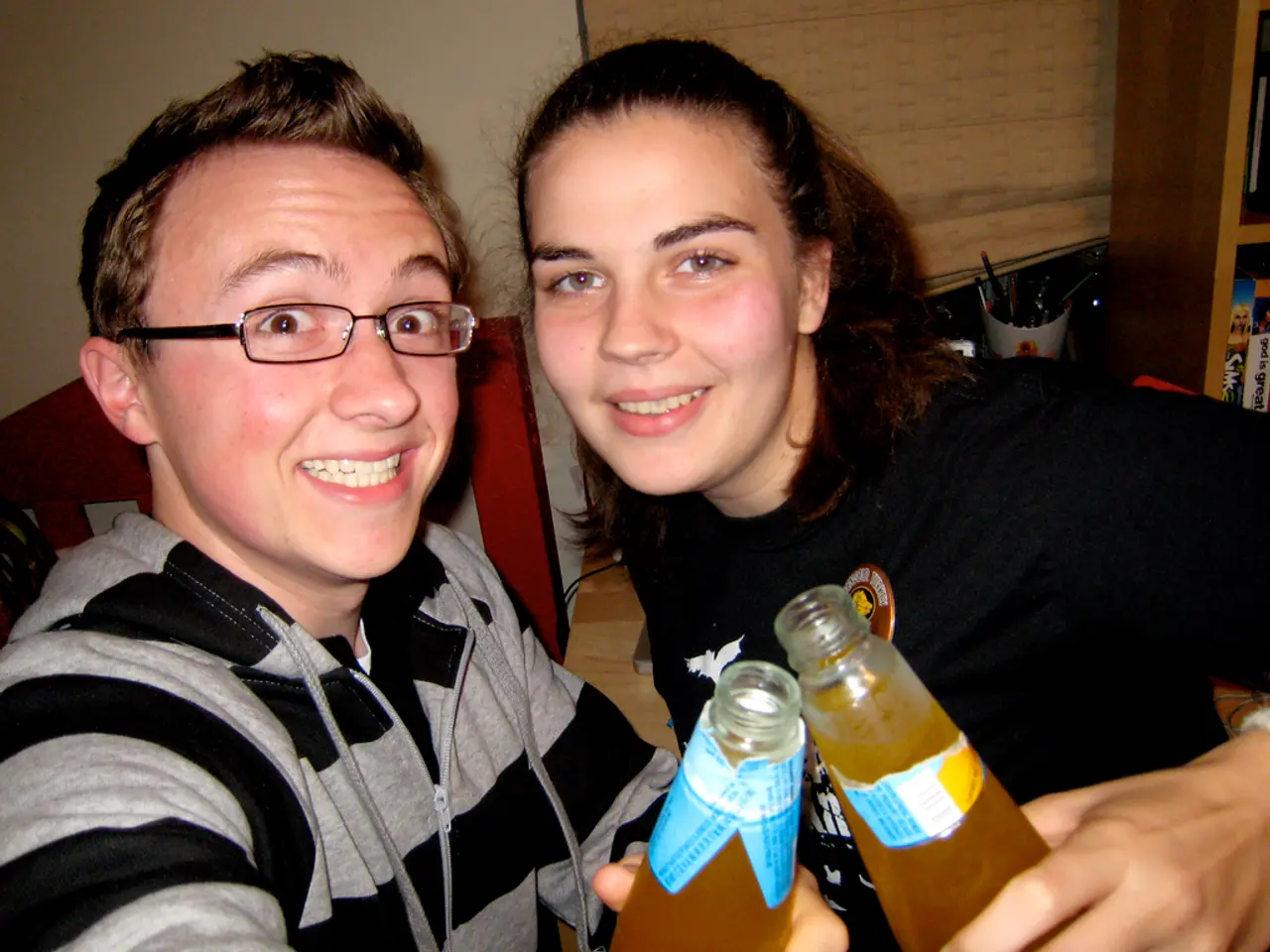 The image consists of a man and a woman holding a soft drink bottle and smiling.