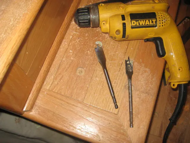 In this picture we can see a table. On the table we can see a drilling machine with wire and...