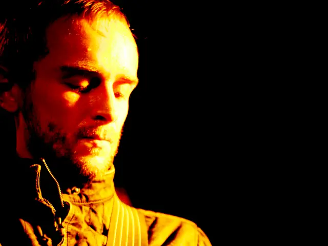 In this picture we can see a man who is playing guitar.