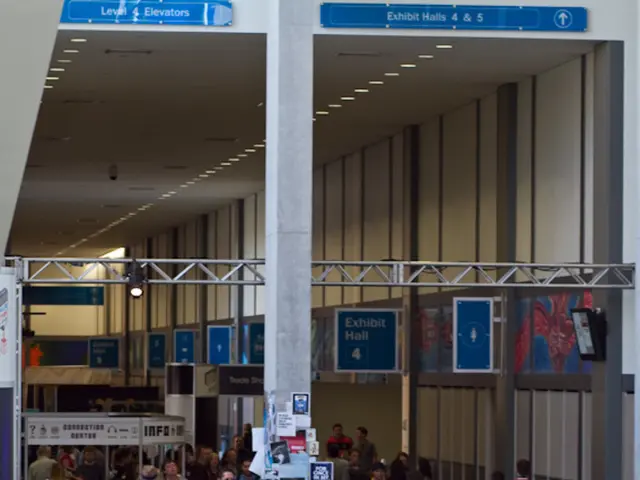 The picture is from inside an airport there are lot of people waiting in the lobby some of them the...