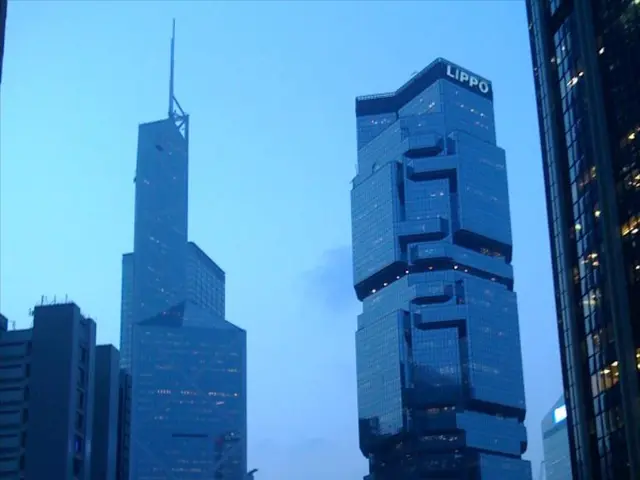 In this image, we can see buildings and at the bottom, there are lights, boards and we can see a...