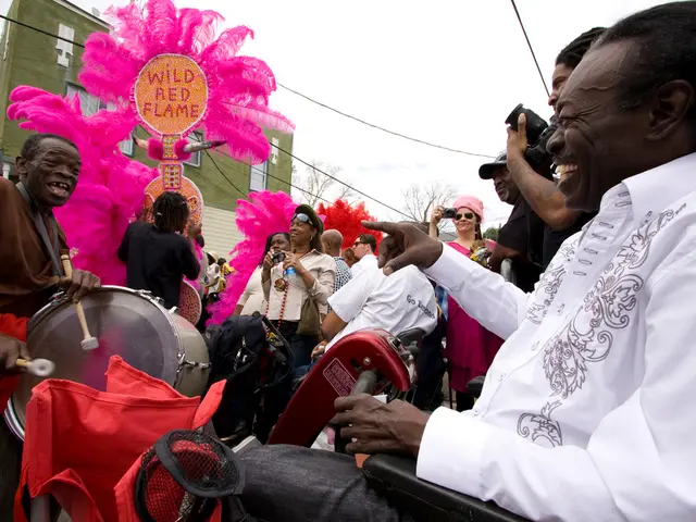 A man is sitting in a automated vehicle. There is another man playing drums in front. There some...